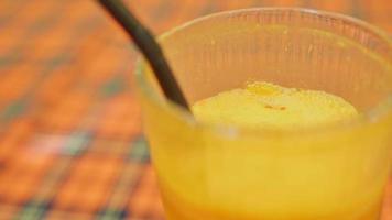 Traditional armenia yellow juice drink in glass with straw. Caucasus culture and foods concept video