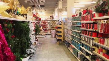 Aisle view shelves full with xmas decorations for home festive preparation with no people . Post xmas sales concept video