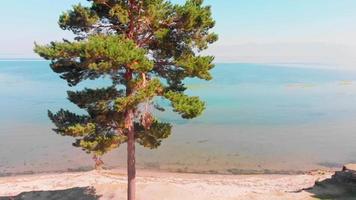 Aerial panning view scenic blue lake panorama with horizon outdoors. Armenia Sevan lake coastline . Relaxation holiday in caucasus video