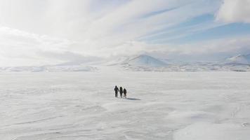 Three person family walk and explore together beautiful winter nature together. Isolated travelous family background.