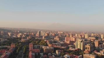 Aerial static panoramic view city Yerevan panorama with Ararat mountain background, city architectural buildings , Mount Ararat, Armenia in clear day with hazy morning in cit