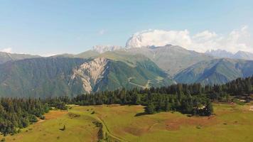 Aerial view of caucasus mountains landscape with Ushba summit peak in background video