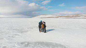 Slomo aerial view family together pose holiday photo standing isolated in scenic winter landscape. Freedom joy travel together concept video