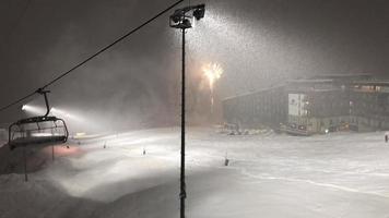 Gudauri, Georgia, 2020 - Static view of spectacular fireworks in Gudauri ski resort with skiers at night skiing video