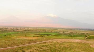 Luftanflug Blick auf das neblige Ararat-Panorama mit bunten landwirtschaftlichen Feldern im Sommer video