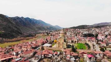 Cinematic aerial rising view over former Georgia capital Mtskheta. Orthodox cathedral and historical sites sightseeing caucasus