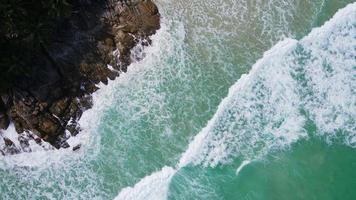 Aerial view of sand beach and water surface texture. Foamy waves with sky. Beautiful tropical beach. Amazing Sandy coastline with white sea waves. Nature, seascape and summer concept. video