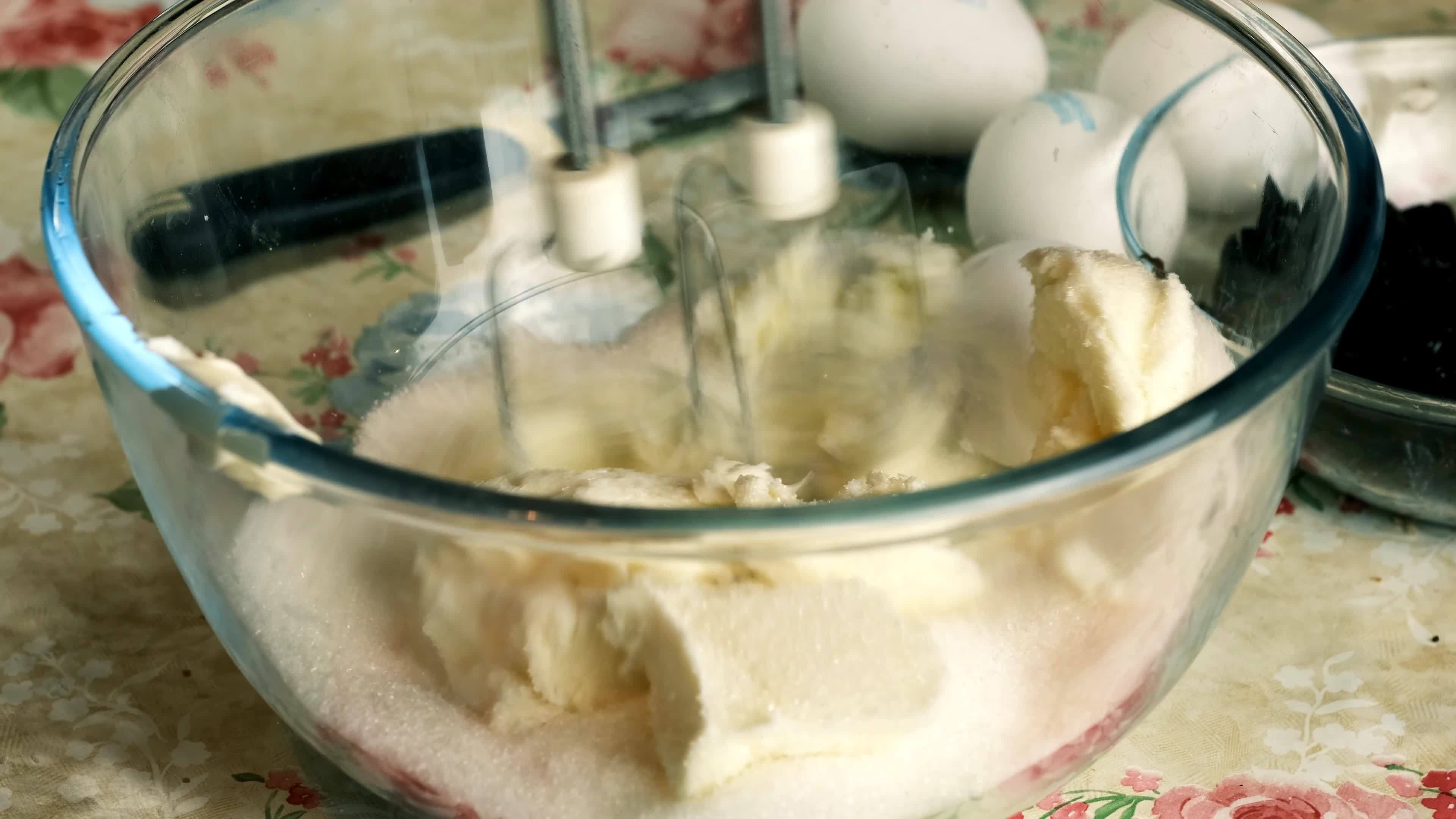 Kneading dough with hand electric mixer. Process of beating the dough