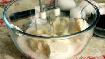 Kneading dough with hand electric mixer. Process of beating the dough using an electric mixer. video