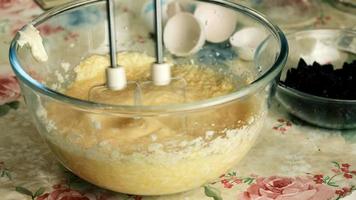 Kneading dough with hand electric mixer. Process of beating the dough using an electric mixer. video