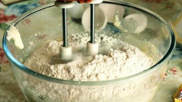 Kneading dough with hand electric mixer. Process of beating the dough using an electric mixer. video