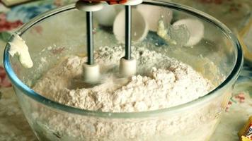 Kneading dough with hand electric mixer. Process of beating the dough using an electric mixer. video