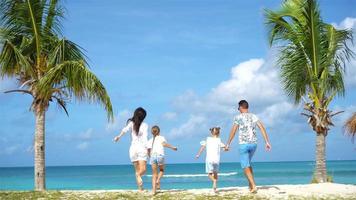 Family on the beach on caribbean vacation have fun