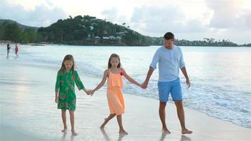 Father and kids enjoying beach summer tropical vacation. SLOW MOTION video