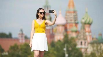 Happy young urban woman in european city. video