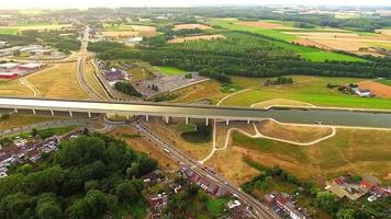 aerial view down towards Pont du sart aqueduct in Belgium with cars passing underneath in roundabout. Architecture and modern european aquaducts. video