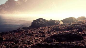 Atmospheric landscape with mountain lake among moraines in rainy weather video