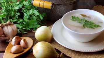 congee in ceramic bowl on rustic wooden table, traditional rice porridge typical of Asian cuisine video