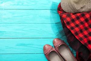 Different pairs of female shoes on blue wooden floor, Top view and copy space photo