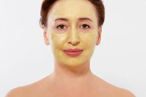 Middle age macro woman face. Summer anti aging collagen mask on woman wrinkle face isolated on white background. Spa and menopause concept. Copy space photo