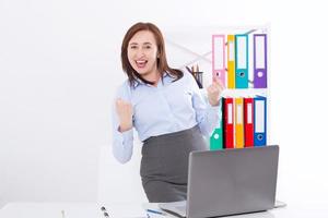 Happy and successful businesswoman raising her arms at office background and celebrating success isolated on white. mock up and copy space. Business concept photo