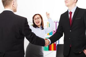 Successful business partnership concept with businessmans handshake. Happy businesswoman at office background. Team work businessmen handshaking after profitable deal. Selective focus. Banner