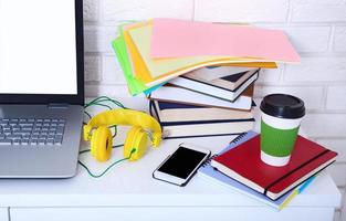 Cup of coffee on modern workspace with electronic devices and copy space. Selective focus photo