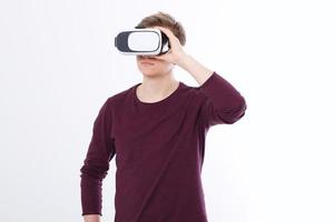 Young man in virtual reality glasses isolated on white background. vr concept. Template and blank shirt. Copy space and mock up photo