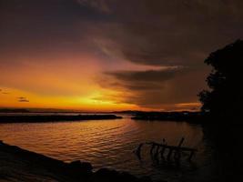 beautiful sunset silhouette on the beach photo