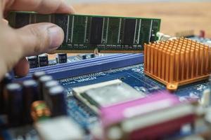 Hand assembled to inspect the electronic circuit board. photo