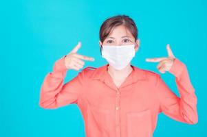 Asian women have to use a face mask to protect against dust pollution and prevent infection from viruses photo