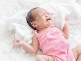A bastard newborn baby crying in bed Because she was hungry and sick