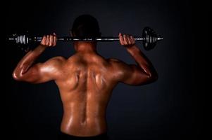 The strong Asian man lifted his dumbbell regularly to keep his muscles strong and beautiful photo