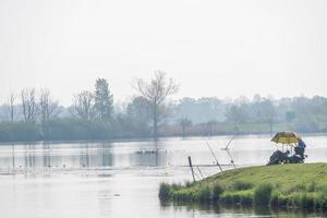 river with fishing man photo