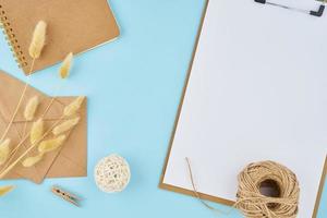 Zero waste concept. White sheet on clipboard, craft envelopes photo