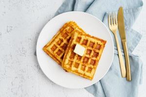 Chaffle, ketogenic diet health food. Homemade keto waffles with egg, mozzarella cheese. Gluten - free and carb-free. White background. photo
