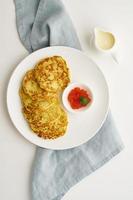 Zucchini pancakes with potato and red caviar, fodmap keto diet top view photo