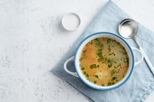 chicken soup, scandinavian homemade food with on blue stone table, copy space, top view photo