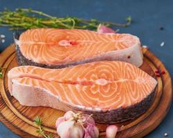 Two salmon steaks, top view, close up. Fish fillet, large sliced portions on a chopping board