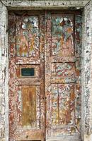 old cracked brown door on the front of the house photo