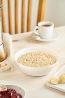 Oatmeal, large bowl of tasty healthy porridge for breakfast, morning meal photo