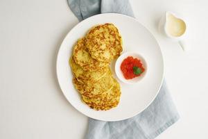 Zucchini pancakes with potato and red caviar, fodmap keto diet top view photo
