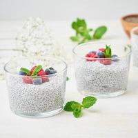 Chia pudding with fresh berries raspberries, blueberries. Two glass photo