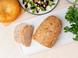 Terrine, meat loaf. Baked Turkey ground meat. Traditional French and American dish. Top view, white marble background