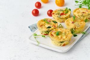omelet with tomatoes and bacon, baked eggs with spinach and broccoli photo