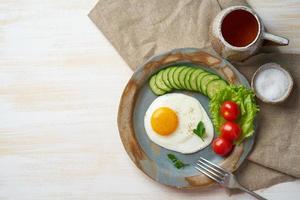 Fried egg, vegetables. Paleo, keto, fodmap diet. Copy space, top view. Healthy diet concept photo