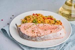 Steam salmon and vegetables, Paleo, keto, fodmap diet. White plate on a blue table, side view, copy space