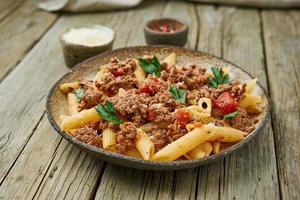 Bolognese pasta. Fusilli with tomato sauce, ground minced beef. Traditional italian cuisine. Side view.