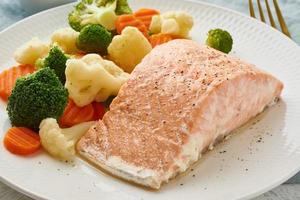 Steam salmon and vegetables, Paleo, keto, fodmap, dash diet. Mediterranean diet with steamed vegetables photo