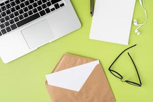 Concept of receiving letter in craft paper envelope at modern workspace, from above photo